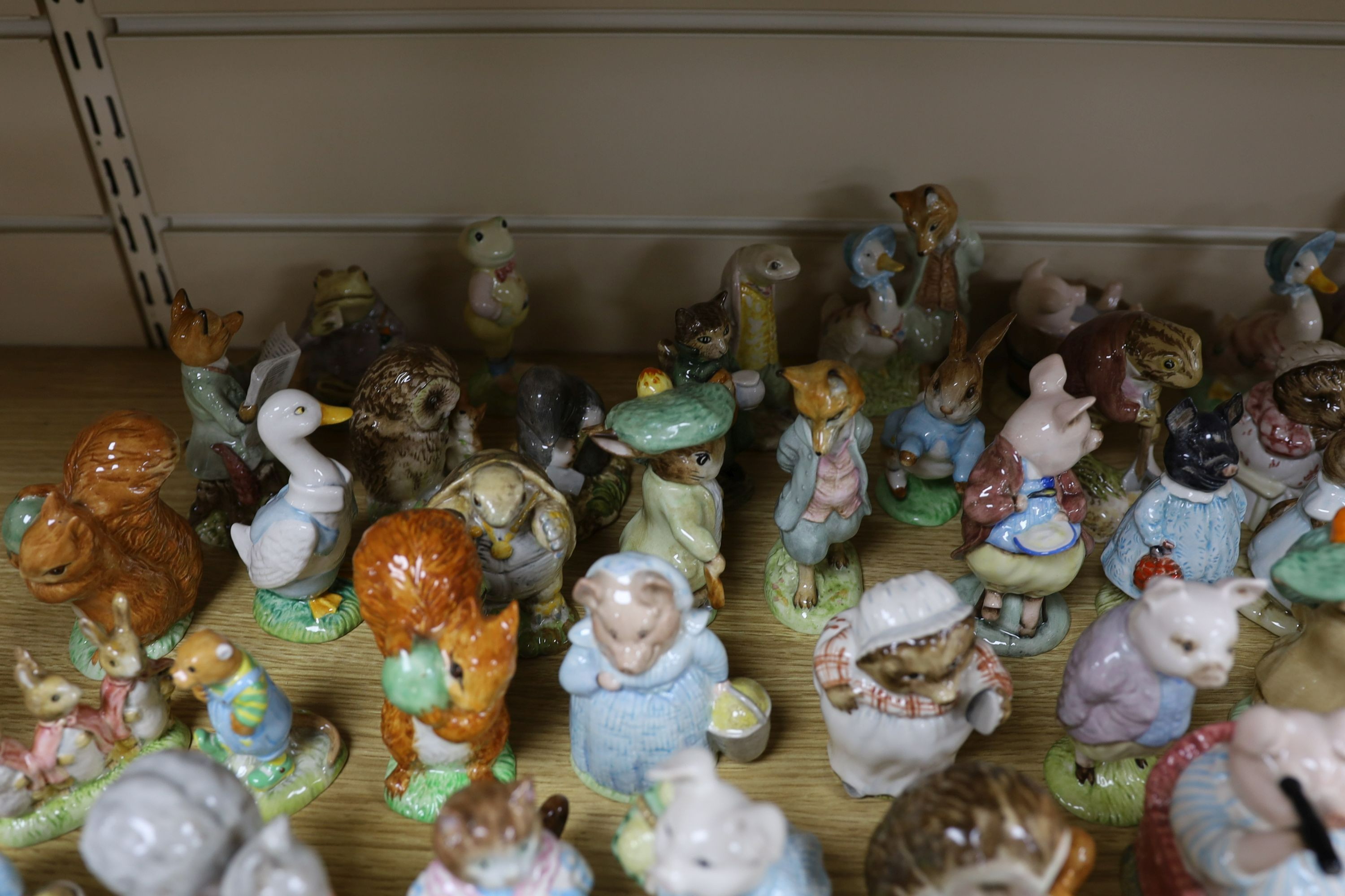 A large collection of Beatrix Potter ceramic figures by Royal Doulton, Beswick and Royal Albert, to include ‘Sir Isaac Newton’ and ‘Mr McGregor’